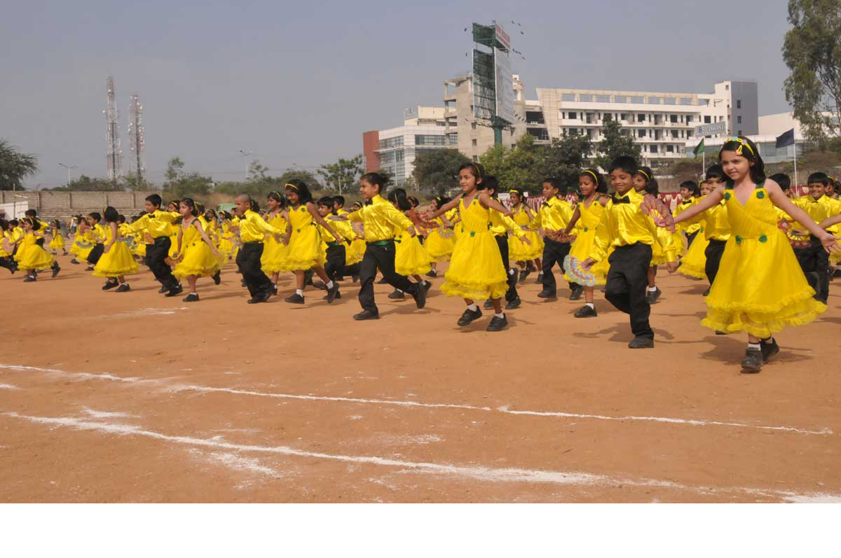 Students performing in coordinated costumes at a school annual day event