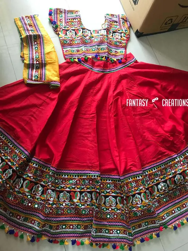Reference photo: Red skirt with embroidered border, tassel trim, choli and yellow dupatta